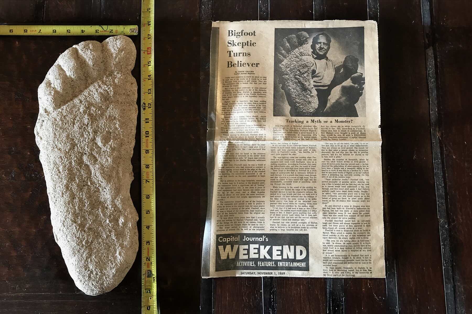Bigfoot footprint cast next to a newspaper clipping